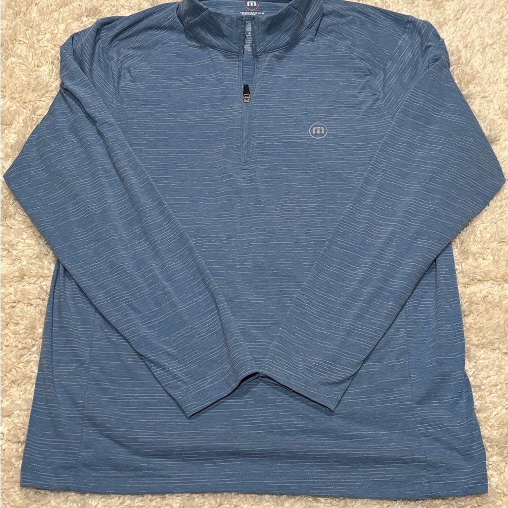 TravisMathew men's quarter-zip pullover made polyester, cotton, and spandex